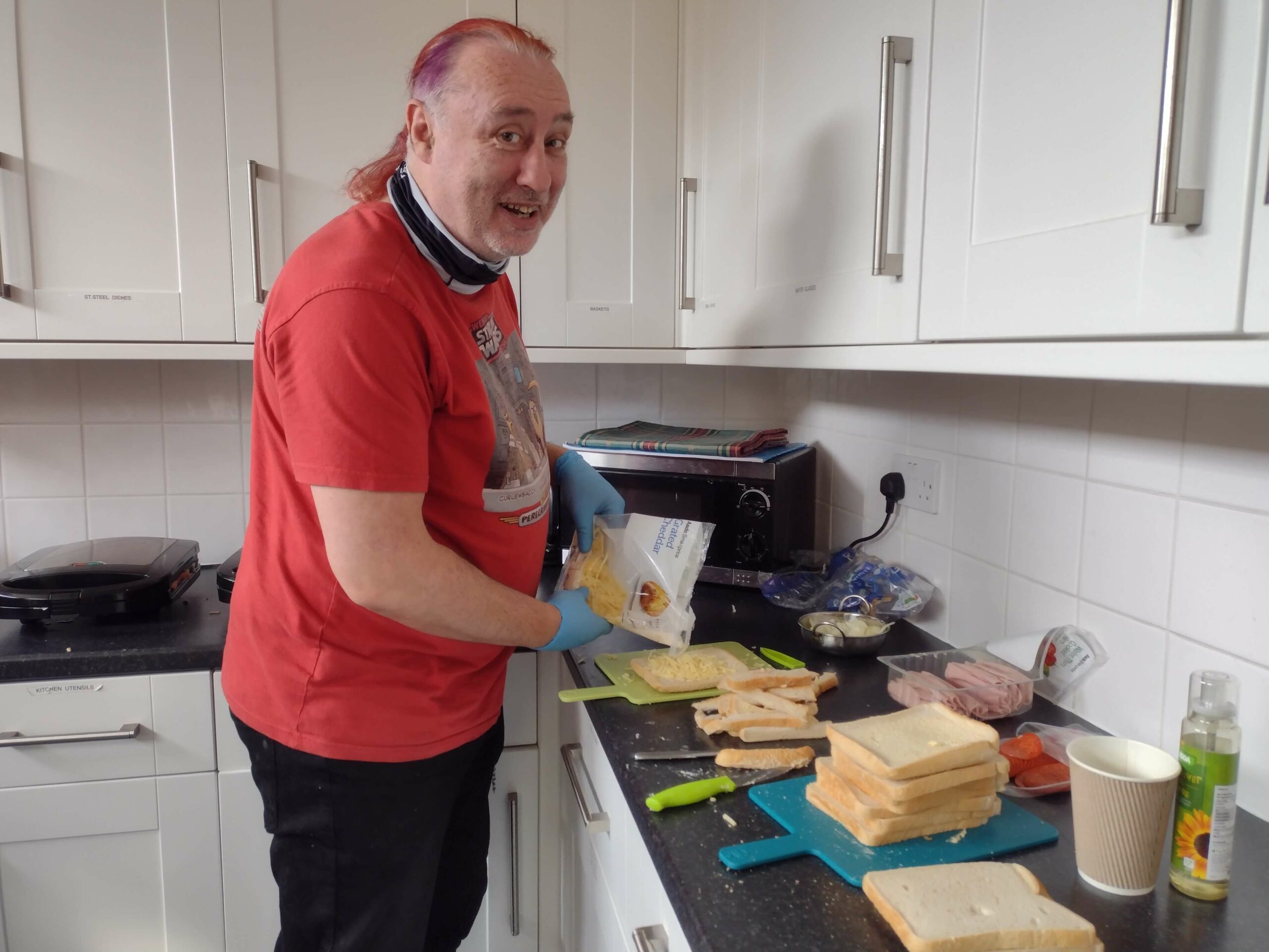 Man in recovery in kitchen making a toastie