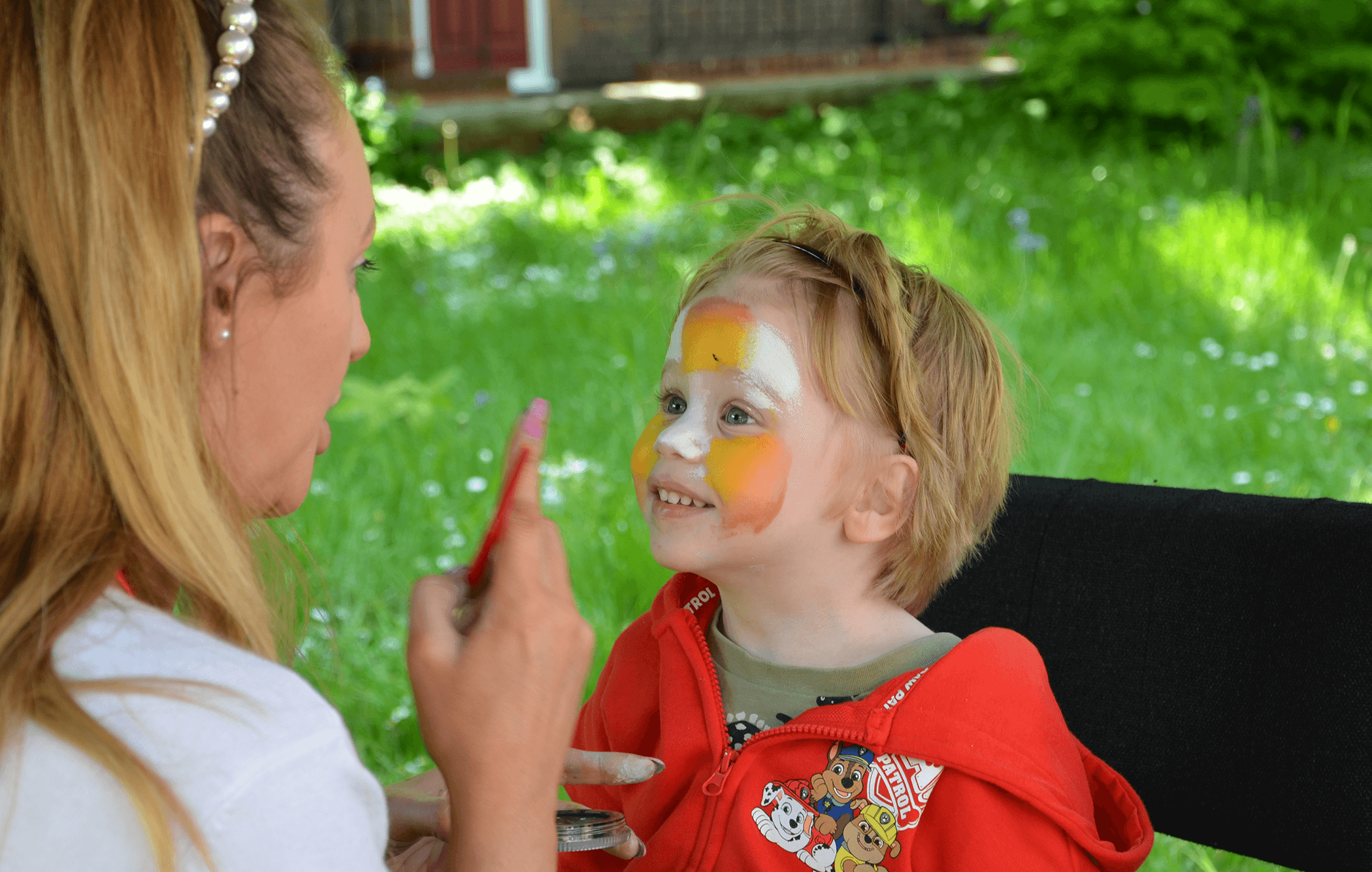 A child having their face painted