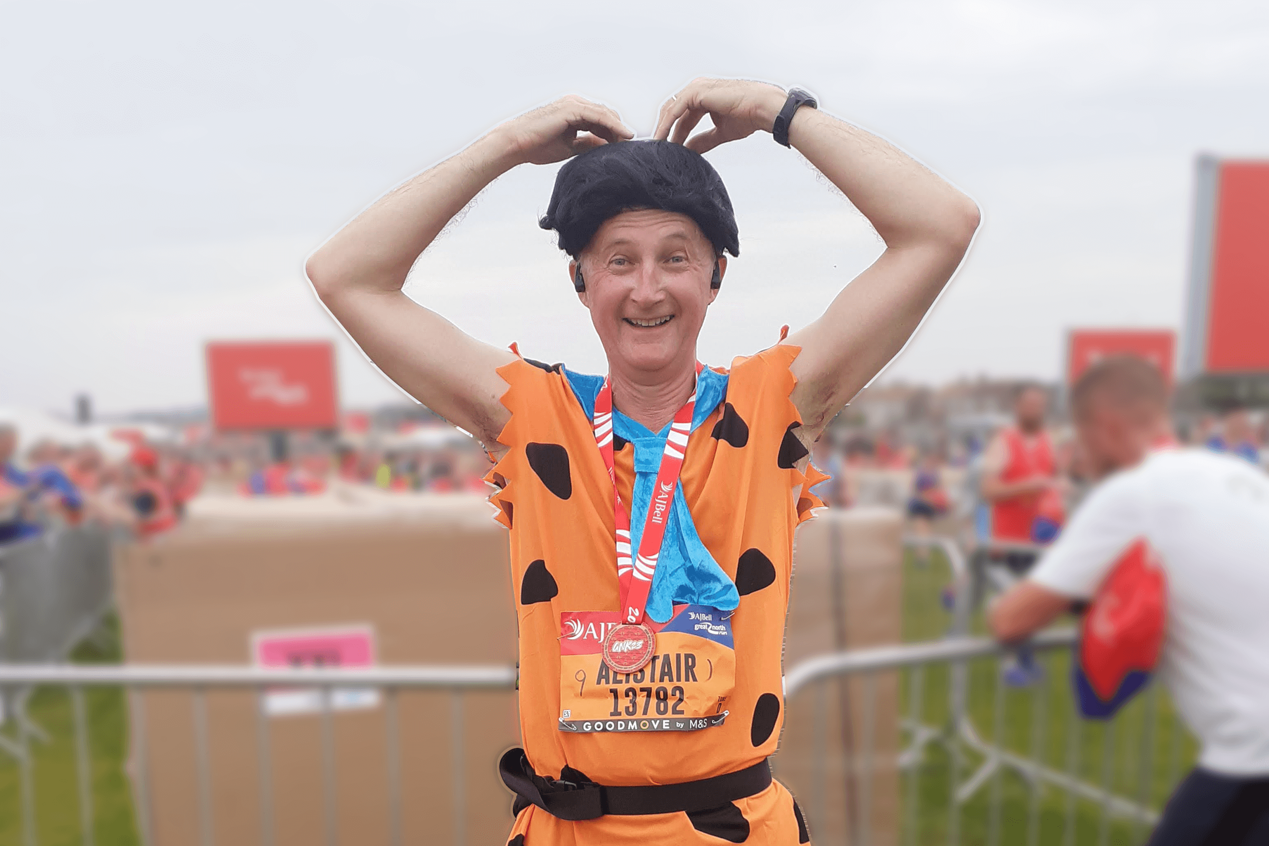 A man wearing a fred flintstone costume and with his hands on his head