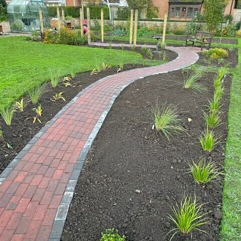A garden with winding, paved path