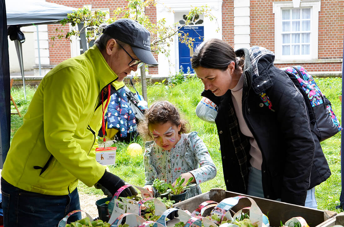 Haskins support a lone parent and their child with potting a summer bedding plant