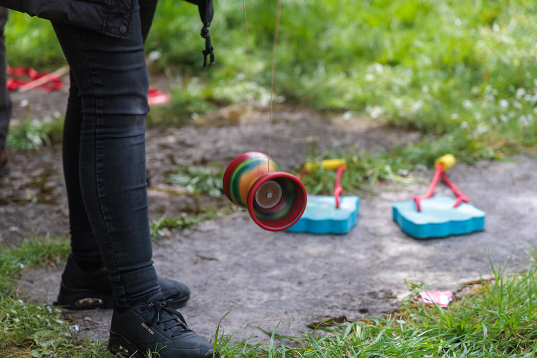 A young person plays with a diablo