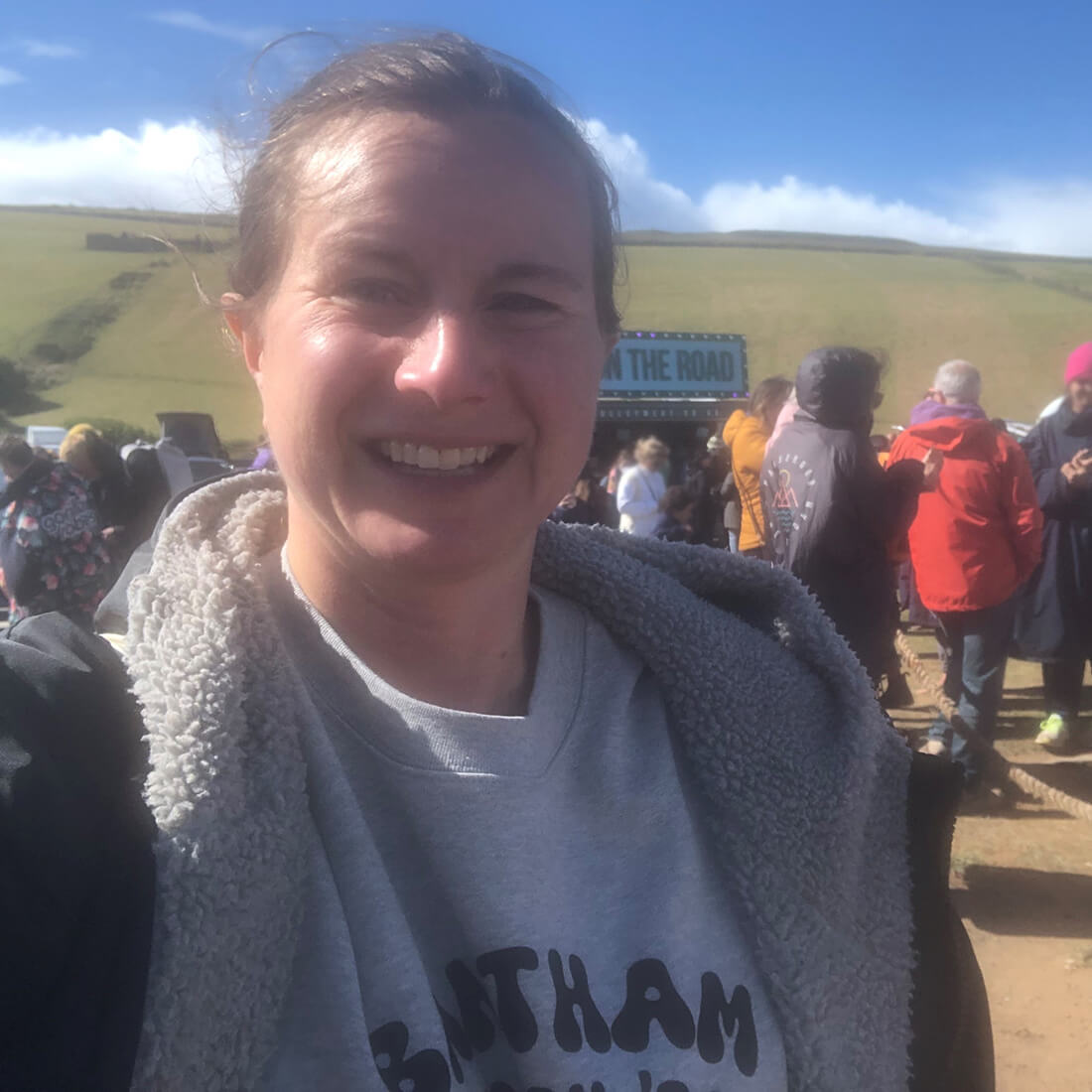 A head and shoulders photo of a woman looking at the camera and smiling