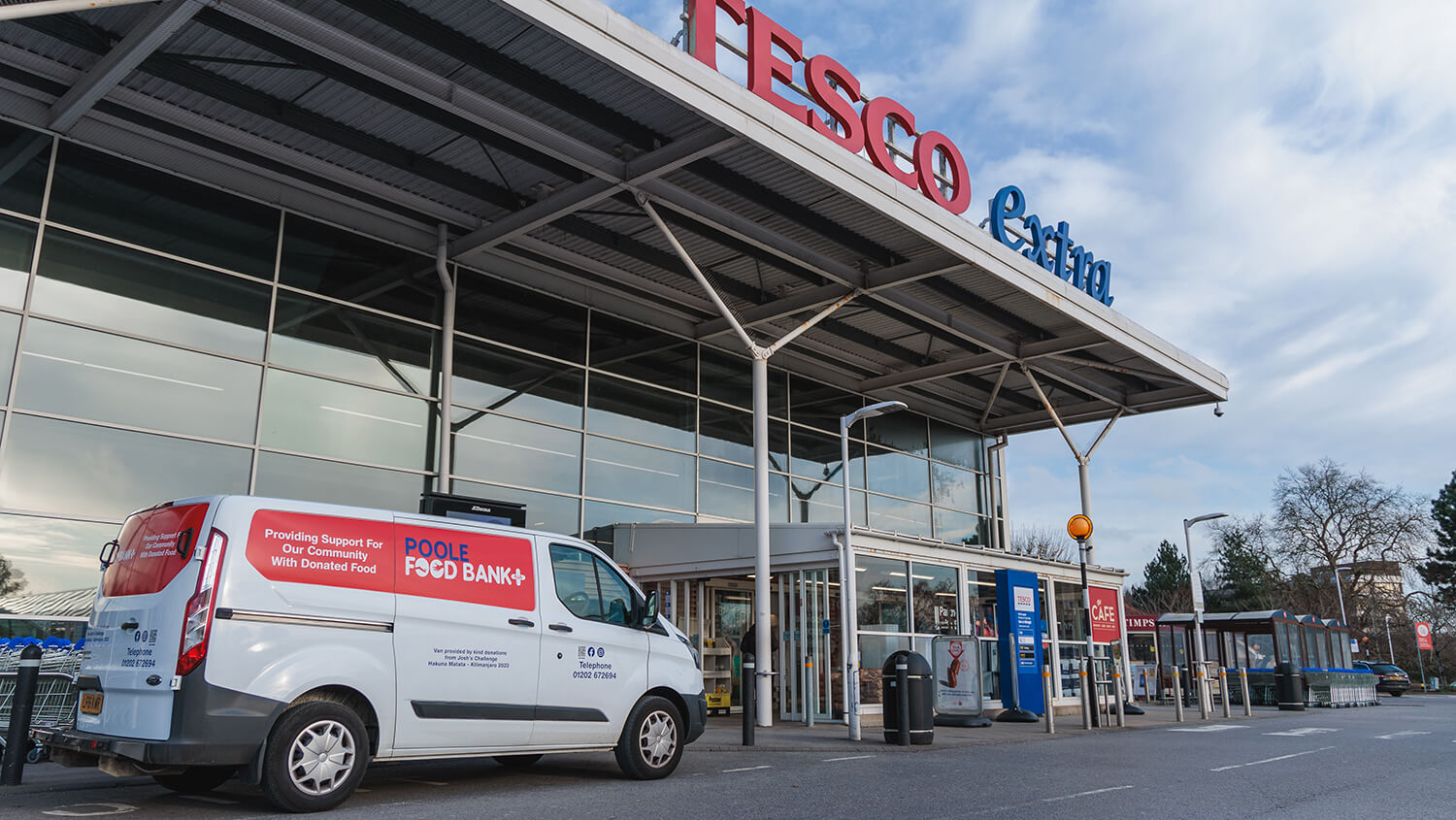 A white van parked outside a Tesco store